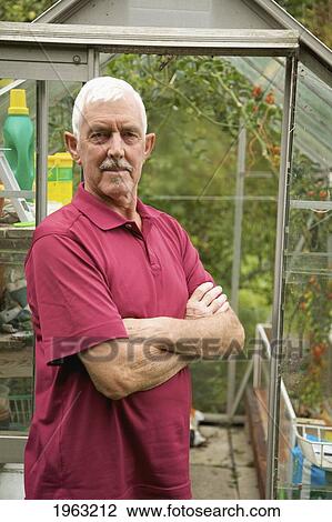 a man standing in front of a greenhouse; naas, county kildare, ireland View Large Photo Image Stock Image - a man standing in front of a greenhouse; naas, county kildare, ireland. Fotosearch