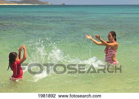 a mother and daughter playing in the water together at cabo pulmo; baja california sur mexico View Large Photo Image Stock Image - a mother and daughter playing in the water together at cabo pulmo; baja california sur mexico. Fotosearch