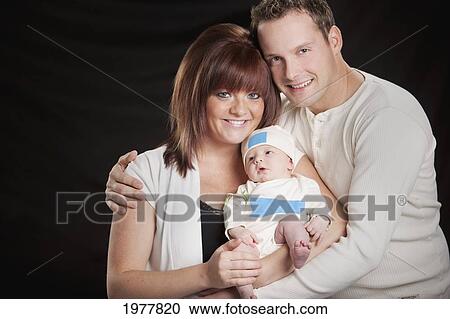 a mother and father hold a newborn baby; edmonton alberta canada View Large Photo Image Stock Image - a mother and father hold a newborn baby; edmonton alberta canada. Fotosearch