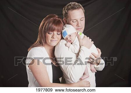 a mother and father hold a newborn baby; edmonton alberta canada View Large Photo Image Stock Photo - a mother and father hold a newborn baby; edmonton alberta canada. Fotosearch