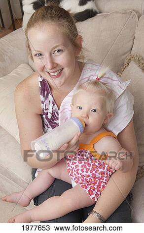 a mother feeds her baby girl with a bottle; millet alberta canada View Large Photo Image Stock Image - a mother feeds her baby girl with a bottle; millet alberta canada. Fotosearch