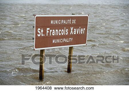 a municipality sign in high water levels after flooding; st. francois xavier, manitoba, canada View Large Photo Image Stock Photo - a municipality sign in high water levels after flooding; st. francois xavier, manitoba, canada. Fotosearch