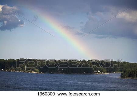 a rainbow over a lake; stockholm, sweden View Large Photo Image Stock Image - a rainbow over a lake; stockholm, sweden. Fotosearch