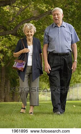 a senior couple walk through a park; edmonton, alberta, canada View Large Photo Image Stock Photography - a senior couple walk through a park; edmonton, alberta, canada. Fotosearch