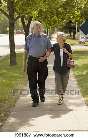 a senior couple walking together; edmonton, alberta, canada View Large Photo Image Stock Photo - a senior couple walking together; edmonton, alberta, canada. Fotosearch