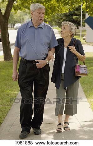 a senior couple walking together; edmonton, alberta, canada View Large Photo Image Stock Photo - a senior couple walking together; edmonton, alberta, canada. Fotosearch