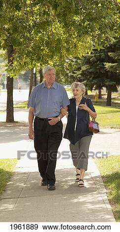 a senior couple walking together; edmonton, alberta, canada View Large Photo Image Stock Photo - a senior couple walking together; edmonton, alberta, canada. Fotosearch