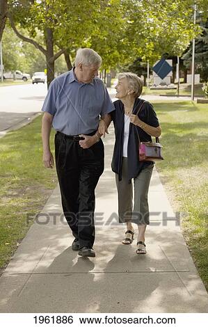 a senior couple walking together; edmonton, alberta, canada View Large Photo Image Stock Photograph - a senior couple walking together; edmonton, alberta, canada. Fotosearch