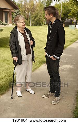a senior woman talking with a teenage boy; edmonton, alberta, canada View Large Photo Image Picture - a senior woman talking with a teenage boy; edmonton, alberta, canada. Fotosearch