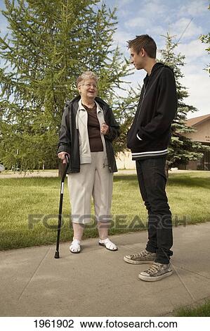 a senior woman talks with a teenage boy; edmonton, alberta, canada View Large Photo Image Stock Image - a senior woman talks with a teenage boy; edmonton, alberta, canada. Fotosearch
