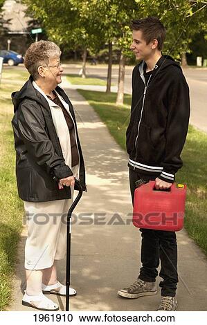 a senior woman talks with a teenage boy; edmonton, alberta, canada View Large Photo Image Stock Image - a senior woman talks with a teenage boy; edmonton, alberta, canada. Fotosearch