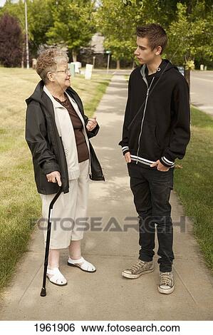 a senior woman talks with a teenage boy; edmonton, alberta, canada View Large Photo Image Stock Photograph - a senior woman talks with a teenage boy; edmonton, alberta, canada. Fotosearch
