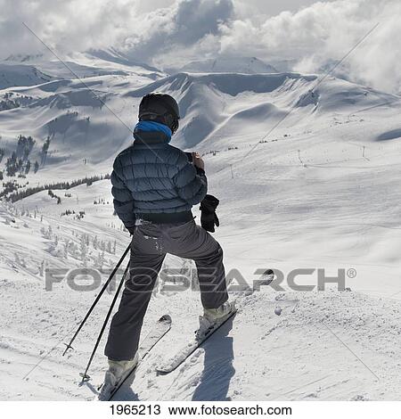 a skier pauses on the trail to look out over the mountains; whistler british columbia canada View Large Photo Image Stock Image - a skier pauses on the trail to look out over the mountains; whistler british columbia canada. Fotosearch