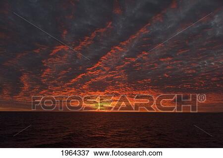 Stock Photo - a sunset over the pacific ocean; galapagos, equador. Fotosearch