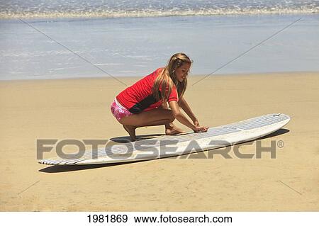 a surfer works on her surfboard on cerritos beach; todos santos baja california mexico View Large Photo Image Stock Photo - a surfer works on her surfboard on cerritos beach; todos santos baja california mexico. Fotosearch