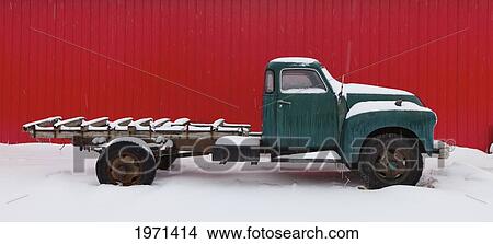 Picture - a vintage pickup truck sits in the snow; alberta canada. Fotosearch