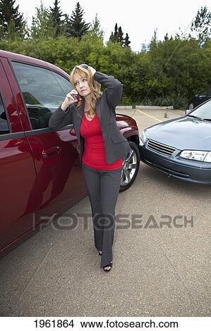 a woman makes a phone call for help after she gets into a car accident; edmonton, alberta, canada View Large Photo Image Picture - a woman makes a phone call for help after she gets into a car accident; edmonton, alberta, canada. Fotosearch