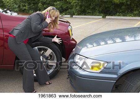a woman makes a phone call for help after she gets into a car accident; edmonton, alberta, canada View Large Photo Image Stock Image - a woman makes a phone call for help after she gets into a car accident; edmonton, alberta, canada. Fotosearch