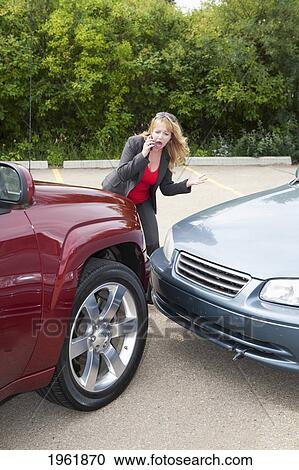 a woman makes a phone call for help after she gets into a car accident; edmonton, alberta, canada View Large Photo Image Stock Image - a woman makes a phone call for help after she gets into a car accident; edmonton, alberta, canada. Fotosearch