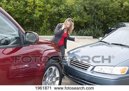 a woman makes a phone call for help after she gets into a car accident; edmonton, alberta, canada View Large Photo Image Stock Image - a woman makes a phone call for help after she gets into a car accident; edmonton, alberta, canada. Fotosearch