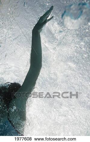 Stock Photo - a woman swimming underwater; tarifa cadiz andalusia spain. Fotosearch