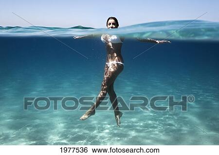 a woman's body immersed in water wearing a two piece bathing suit; tarifa cadiz andalusia spain View Large Photo Image Stock Photograph - a woman's body immersed in water wearing a two piece bathing suit; tarifa cadiz andalusia spain. Fotosearch