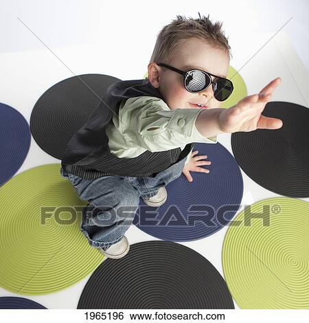 a young boy wearing sunglasses reaching upwards; edmonton alberta canada View Large Photo Image Stock Photograph - a young boy wearing sunglasses reaching upwards; edmonton alberta canada. Fotosearch