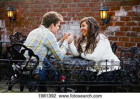 a young couple holding hands at a table; bellingham washington united states of america View Large Photo Image Stock Image - a young couple holding hands at a table; bellingham washington united states of america. Fotosearch