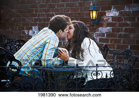a young couple kissing at a table; bellingham washington united states of america View Large Photo Image Stock Image - a young couple kissing at a table; bellingham washington united states of america. Fotosearch