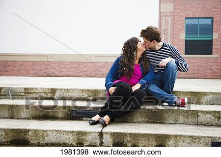 Stock Photo - a young couple kissing on steps; bellingham washington united states of america. Fotosearch