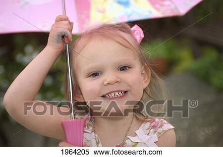 a young girl smiling and holding an umbrella over her head; moraga, california, united states of america View Large Photo Image Stock Photography - a young girl smiling and holding an umbrella over her head; moraga, california, united states of america. Fotosearch