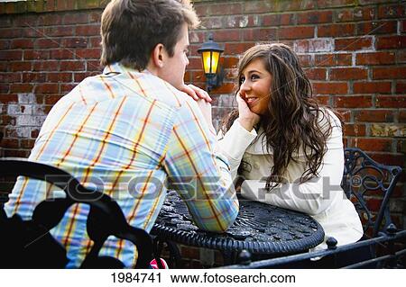 a young man and woman sitting at a table together; bellingham washington united states of america View Large Photo Image Stock Image - a young man and woman sitting at a table together; bellingham washington united states of america. Fotosearch
