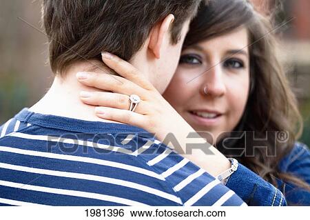a young woman wearing a diamond ring embraces her fiance; bellingham washington united states of america View Large Photo Image Stock Photograph - a young woman wearing a diamond ring embraces her fiance; bellingham washington united states of america. Fotosearch