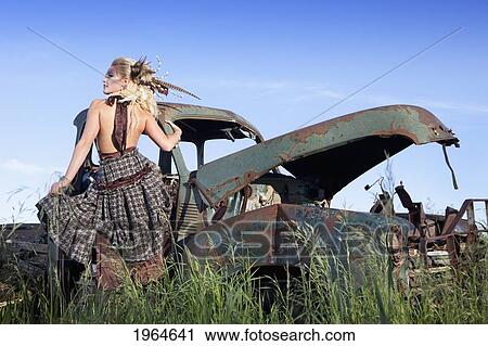 a young woman with dramatic makeup and hairstyle by an abandoned vintage car; nisku alberta canada View Large Photo Image Stock Image - a young woman with dramatic makeup and hairstyle by an abandoned vintage car; nisku alberta canada. Fotosearch