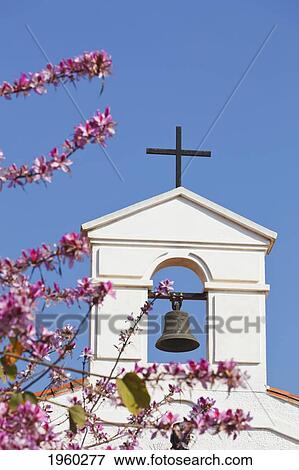 Stock Photo - bell tower of parochial church of the immaculate conception with cherry blossom; arroyo de la miel, malaga province, spain. Fotosearch