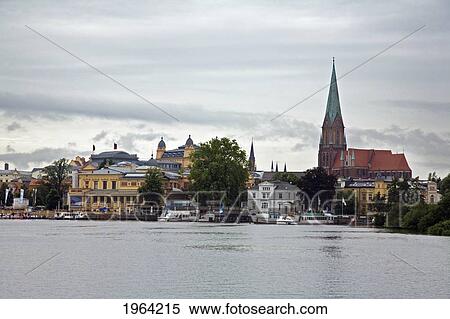 Stock Photography - boats and buildings along the shore; schwerin, mecklenburg, germany. Fotosearch