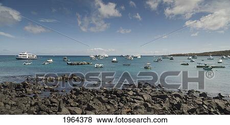 boats in the ocean off the shore of san cristobal island; puerto baquerizo moreno, san cristobal island, galapagos, equador View Large Photo Image Stock Photo - boats in the ocean off the shore of san cristobal island; puerto baquerizo moreno, san cristobal island, galapagos, equador. Fotosearch
