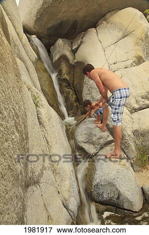 boys exploring in the rocks at sierra la laguna biosphere reserve; baja california sur mexico View Large Photo Image Stock Photo - boys exploring in the rocks at sierra la laguna biosphere reserve; baja california sur mexico. Fotosearch