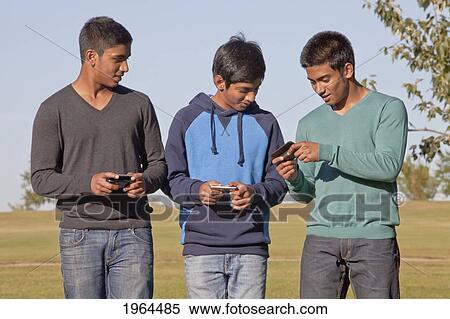 brothers texting and walking through a park; edmonton, alberta, canada View Large Photo Image Stock Photography - brothers texting and walking through a park; edmonton, alberta, canada. Fotosearch