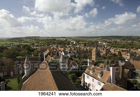 Stock Image - buildings with tiled roofs and pastures in the distance; rye, sussex, england. Fotosearch