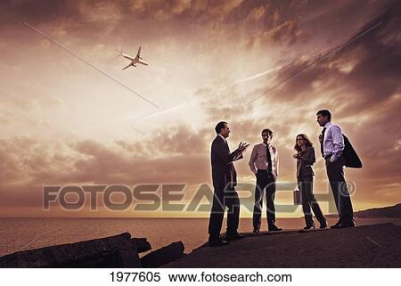 businessmen and a businesswoman stand at the water's edge talking; tarifa cadiz andalusia spain View Large Photo Image Stock Photography - businessmen and a businesswoman stand at the water's edge talking; tarifa cadiz andalusia spain. Fotosearch