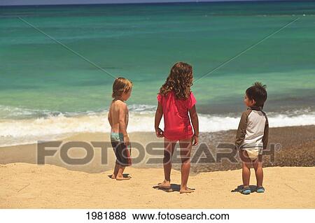 children standing on a beach at the water's edge at cabo pulmo; baja california sur mexico View Large Photo Image Stock Photo - children standing on a beach at the water's edge at cabo pulmo; baja california sur mexico. Fotosearch