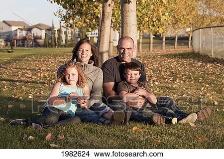 family portrait in a park in autumn; beaumont alberta canada View Large Photo Image Picture - family portrait in a park in autumn; beaumont alberta canada. Fotosearch