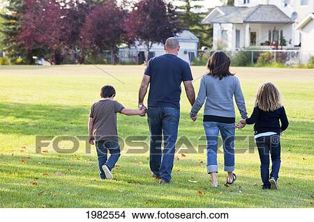 family walking together in a park; beaumont alberta canada View Large Photo Image Picture - family walking together in a park; beaumont alberta canada. Fotosearch