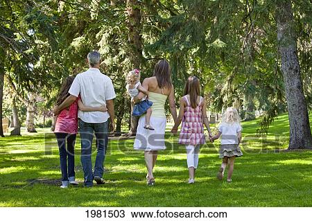 family walking together in a park; edmonton alberta canada View Large Photo Image Stock Image - family walking together in a park; edmonton alberta canada. Fotosearch