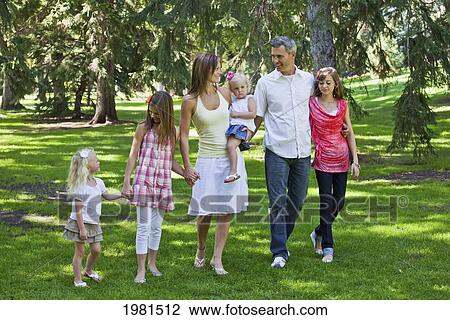 family walking together in a park; edmonton alberta canada View Large Photo Image Stock Image - family walking together in a park; edmonton alberta canada. Fotosearch
