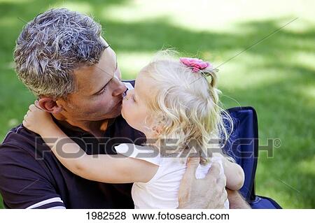 father being kissed by toddler daughter; edmonton alberta canada View Large Photo Image Stock Photo - father being kissed by toddler daughter; edmonton alberta canada. Fotosearch