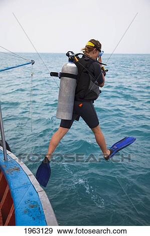 female scuba diver jumps in water; koh tao, thailand View Large Photo Image Stock Photo - female scuba diver jumps in water; koh tao, thailand. Fotosearch