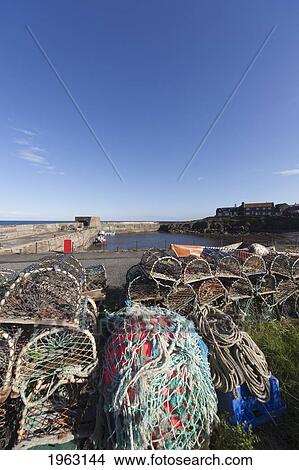 fishing traps and nets on the shore; craster, northumberland, england View Large Photo Image Picture - fishing traps and nets on the shore; craster, northumberland, england. Fotosearch