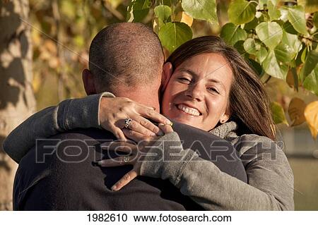 husband and wife in an embrace in a park; beaumont alberta canada View Large Photo Image Stock Image - husband and wife in an embrace in a park; beaumont alberta canada. Fotosearch